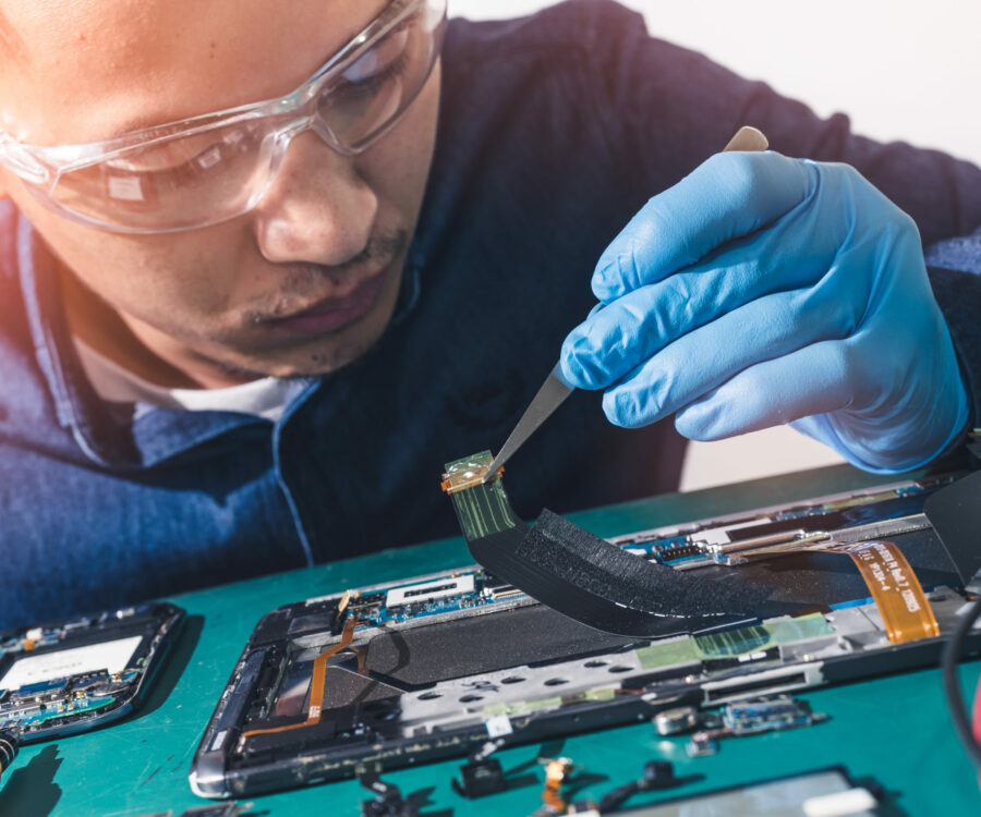 The abstract image of the asian technician repairing a tablet in